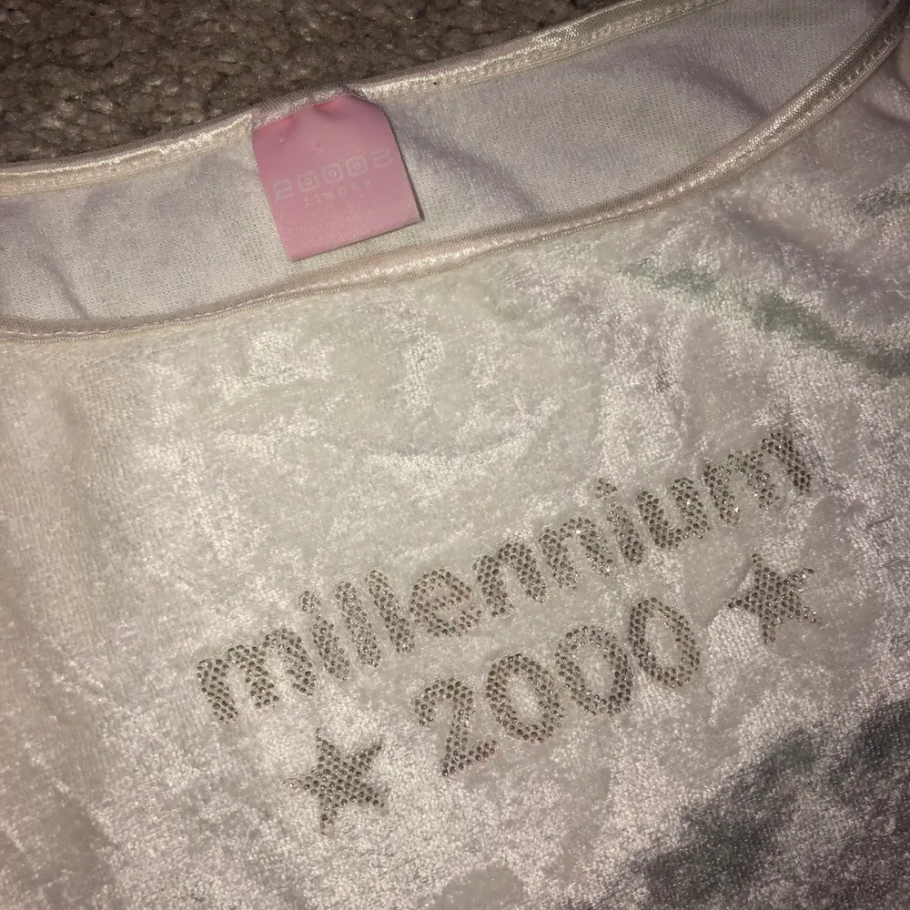 säljer mitt underbara y2k linne då det används alldeles för lite. det är sammets material med texten ’millennium 2000’ i glitter ✨ 🌟 liten fläck på framsidan som jag tror går bort men har inte tid att prova just nu. men tvättar självfallet om någon är intresserad av att köpa. Toppar.