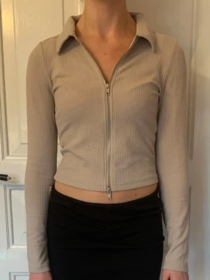 Zip up tröja från H&M - Jag säljer en beige zip up tröja från H&M, märket Divided.