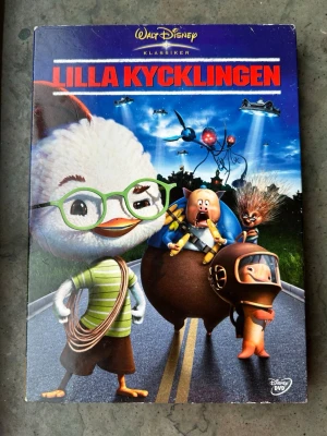 Lilla kycklingen dvd - Lilla Kycklingen (Chicken Little) DVD med svenskt tal. Ljud: Dolby Digital 5.1. Speltid: 77 minuter. Produktionsår: 2005. Region 2.  Finns på språk: Svenska, Finska, Engelska, Isländska   OBS!! skivorna är begagnade så det kan förekomma repor/hairlines på skivorna, men då jag kollar igenom alla filmer jag säljer garanterar jag att alla funkar felfritt om inget annat står! :)