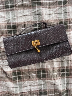 Brun kuvertväska i ormmönstrat läder - Brun clutch väska, fint skick! Längd ca 25cm