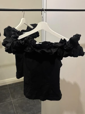 Puffed off shoulder blouse - Elegant Off shoulder blus i linne, med puffig volang runt om. Sitter väldigt fint på. Använd 1 gång, som ny! Stl XS, svart. Köpt i Italien på en söt lokal butik. 