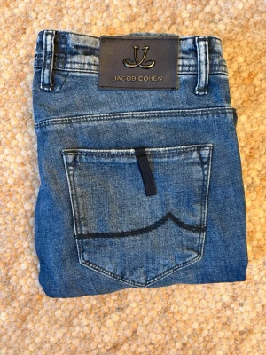 Jacob Cohen 688 comfort limited edition - Säljer ett par feta och extremt sällsynta Jacob Cohen 688 limited edition slim fit, med otroligt unik patch på baksidan👌. Det är en väldigt exklusiv modell och det finns bara 300 exemplar av modellen i hela världen🙌. Nypris ligger mellan 8000-10000 kr🤝. Storleken är size 30 men motsvarar nog ungefär W32 (midja 41/42, längd 105/106). Skick:10/10 i princip nyskick🌟. Hör gärna av er vid frågor eller funderingar👍