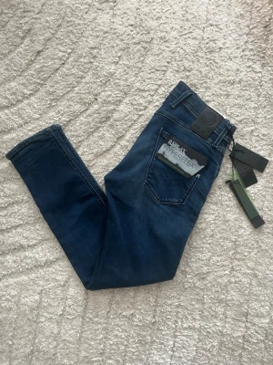 Replay Anbass hyperflex jeans  - Helt nya! Replay Anbass hyperflex jeans i mörkblått med en slim passform. Midja 37cm, längd 97cm. JAG SKICKAR EJ FLER BILDER NÄR JAG BÄR JEANSEN! för bättre inblick i passformen rekommenderar jag att googla på modellnamnet. För storleksguide kolla måtten noggrant då jeansen alltid kan vara uppsydda heller krympta och jag ej tar emot returer :) 1,88