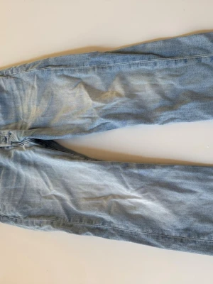 Ljusblå Levi's jeans med raka ben - Säljer ett par ljusblå Levi's jeans med klassisk femficksdesign och raka ben. Jeansen har en snygg tvättad look och är tillverkade i denim med en skinnpatch bak i midjan. Skriv ifall du har några fler frågor!