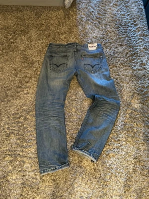 Levi's 504 blå raka jeans - Säljer ett par Levis 504or med fades och helt sjuka honey combs. Storleken är W33 L32. Skulle säga att de sitter som W32. Gammal modell av 504 som är svår att få tag på, särskilt i detta skick! 