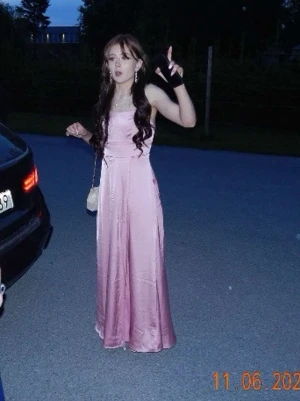 Ljusrosa balklänning  - Elegant ljusrosa långklänning i satin. Klänningen har en slät och glansig yta som ger ett lyxigt intryck. Perfekt för speciella tillfällen och har en klassisk, feminin siluett. Använd en gång, inga fläckar eller skador. Bra i storlek, lite lång på mig (Jag är 155cm)