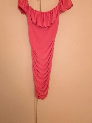 Lång rosa klänning  - Använd max 1 gång. Off shoulder och dragsko liknande på sidorna. Storlek 38