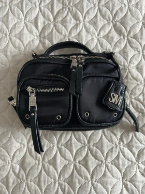 Steve Madden axelremsväska  - Använd några enstaka gånger  Ena dragkedjan har tappat lite färg, annars ny till utseende  Medföljer ett längre band   Längd: 18cm  Höjd: 14cm   PS: Kolla in mina andra annonser, upp till 20% rabatt vid köp av flera artiklar och priset går nästan alltid att diskutera!🩷