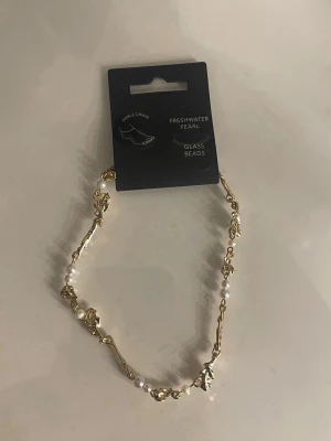 Guld fot länk - Säljer denna fina guldpläterade fot länk från pilgrim.