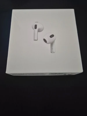 Apple AirPods 3 med MagSafe-laddning - Säljer ett par vita Apple AirPods med MagSafe-laddningsetui. Trådlösa in-ear hörlurar i stilren design, tillverkade i plast. Perfekta för musik, samtal och smidig anslutning till Apple-enheter. Levereras i originalförpackning.