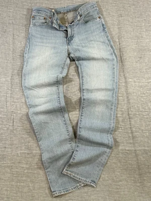 Levi’s 511 Mid Rise Slim Fit Vintage Light Wash W28xL32 - Levi’s 511 slim fit jeans in a clean light wash. Mid-rise fit that sits just right. Slight stretch for comfort. Easy everyday denim that works with everything. Clean fading overall.  Small dot on back right leg (shown in photos).  Waist 36cm, Rise 23cm, Thigh 27cm, Knee 19cm, Leg 16cm, Length 106cm