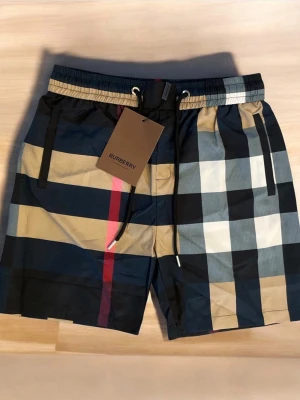 Burberry shorts/badshorts - Säljer dessa riktigt fina oanvända shorts/ badshorts i storlek M! Passar M och S! Perfekta nu i sommar! ⛱️ Hör av er ifall ni har några frågor eller vill ha fler bilder!  ⭐️