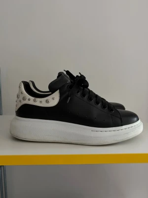 Alexander McQueen Oversized sneaker - Stilrena svarta sneakers från Alexander McQueen med vit hälkappa dekorerad med silvriga nitar. Köpta på vestaire och kvitto finns. Skorna kommer enbart med dustbag.