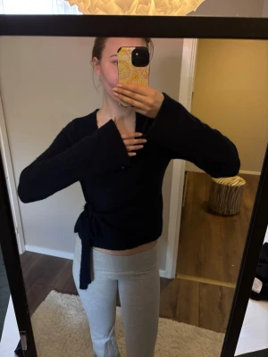 Svart omlottkofta med knytband - Svart omlottkofta med långa ärmar och knytband i midjan. Ifrån Ginatricot i storlek xs😗💕.