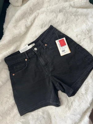 Svarta jeans shorts  - Säljer ett par svarta jeansshorts som är helt oanvända och fortfarande har prislappen kvar. Tyvärr är de för små för mig, därför säljer jag dem vidare.  De är i jättefint skick eftersom de aldrig har använts. Perfekta till sommaren och enkla att matcha med allt.                                                     Går att diskutera pris.   📍 Helt nya 🏷️ Prislapp kvar  Hör gärna av dig om du har frågor eller vill ha fler bilder! 😊