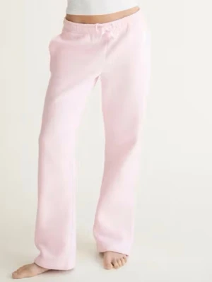 Ljusrosa mjukisbyxor  - Mysiga ljusrosa mjukisbyxor med raka ben och resår i midjan samt dragsko. Tillverkade i mjukt fleecematerial på insidan för extra komfort. Perfekta för chill dagar hemma eller när du vill vara extra bekväm. Har lite gräsfläckar vid fötterna 