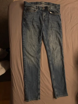 Slim fit jeans från Hampton Republic - Snygga blå slim fit jeans från Hampton Republic med klassisk femficksdesign och diskreta slitningar framtill. Jeansen har normal midja och raka ben, perfekta till en avslappnad stil. Tillverkade i mjukt denimtyg för skön känsla.