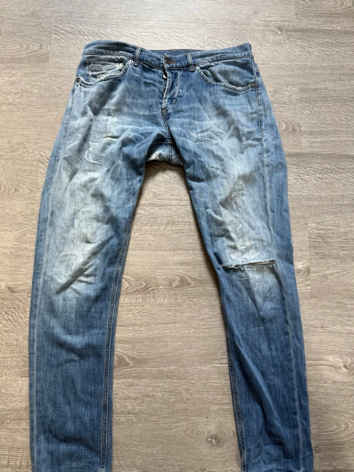 Blå slitna jeans med hål