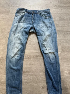 Blå slitna jeans med hål - Säljer ett par blå jeans med slitningar från dondup