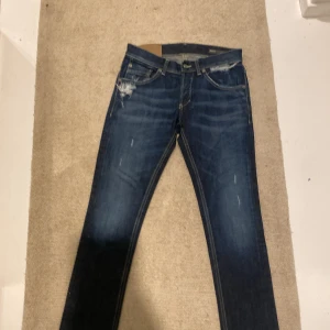 Dondup jeans  - Säljer ett Mörkblå Dondup jeans med lite små slitningar och ripps. Säljs ändast för 580kr äkta Dondup jeans.