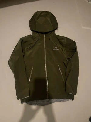 Arcteryx jacka  - Arc’teryx jacka, modell Beta LT. I gott skick, men använd. Gore-Tex behöver återimpregneras eftersom den inte längre stöter bort vatten lika bra. Storlek XL, men upplevs som L enligt mig. Köpt av en vän, därför finns inget kvitto.