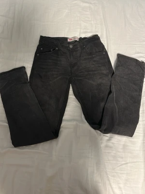 Svarta Levis jeans - Säljer nu dessa svarta Levis jeans i slim fit (inte skinny slim) i storlek 164 som passar upp till 175 cm person ungefär, jeansen har ett litet hål i höger bakficka men det är inget stort som kan trilla igenom. skriv till mig om ni har några frågor eller funderingar kring jeansen! 🤝🌟