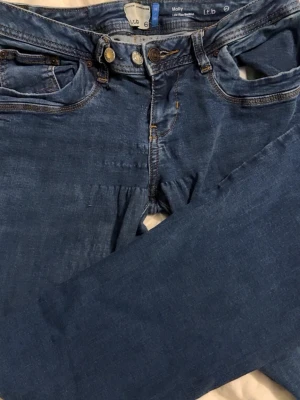 Blå Molly jeans från LTB - Säljer ett par klassiska blå Molly jeans från LTB med raka ben och femficksdesign. Jeansen har dubbla knappar i midjan och snygga detaljer vid fickorna. Materialet är mjukt denim som ger en skön passform.