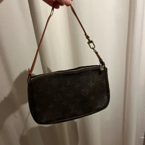 Louis Vuitton väska - Louise Vuitton väska i modellen pochette accessoires. Den är köpt på Vestiaire så har äkthetskontrollerats. Den är i super bra skick.