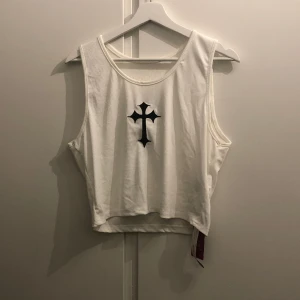 cross croptop  - croppat linne med ett kors på framsidan, fått i present men aldrig använt, den är oversized om man är S-M men passar L om man vill ha den lite tightare, endast testad med lapp 💗