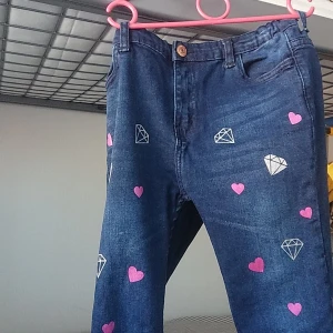 Pants - It is both jeans or pants with heart shapend pic on it. It is for 10 to 11 year old girls. Prices can be lower if interested