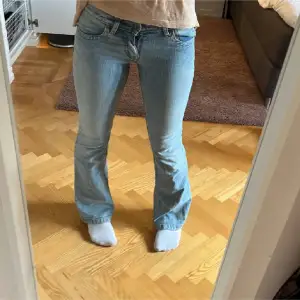 Lågmidjade flare jeans i ljudblå färg.(lånade bilder från förra ägaren). Två små fläckar men syns it alls mycket🤗 (Bild 5) Midja 32cm , Innerbenslängden 80cm❣️