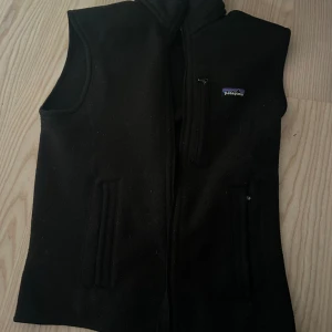 Patagonia väst  - Patagonia fleece väst i färgen svart. Den är i mycket bra skick, säljer pga att den blivit för liten. 