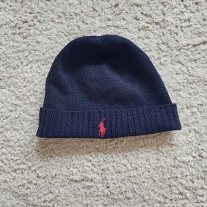 Ralph Lauren Merino Wool Beanie - Ralph Lauren Merino Wool Beanie i väldigt bra skick.   Mörkblå  100 % merino ull  Nypris ca 700 kr