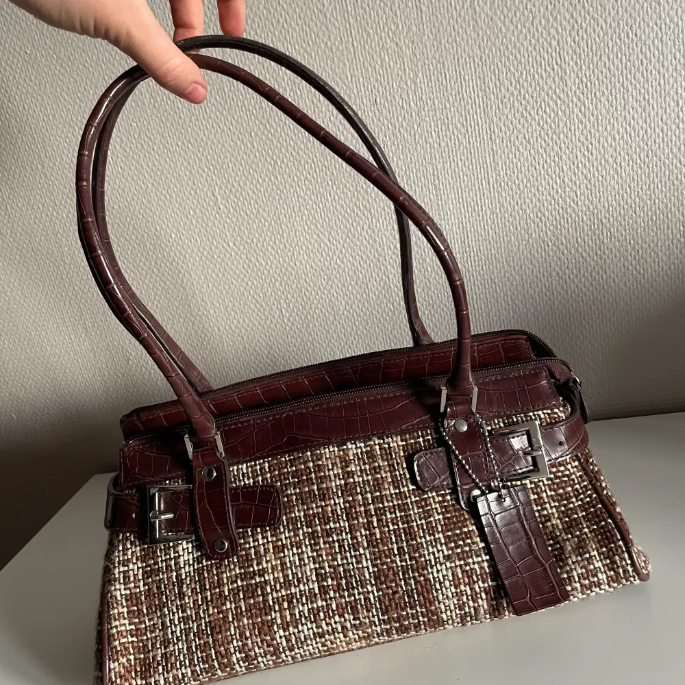 Mindre brun vintage handväska i bra skick med fyra inre fack varav två med dragkedja. Frakt ingår inte☺️. Väskor.