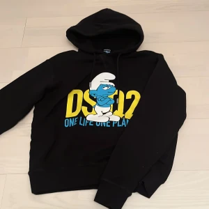 Dsquared hoodie  - Hej säljer en jättefin helt ny dsquared x smurfs hoodie som är sjukt cool i designen den är självklart äkta och kvitto finns så de bara skriva om ni vill ha bild nypris på denna är 6000kr 