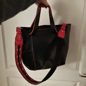Svart väska med röda detaljer 