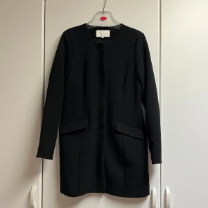 Vår/höstjacka från Vila - En svart vår/höst jacka från Vila 🖤 Längre modell som slutar innan knäna på mig som är 158 cm 🩶Bra kvalitet på kedjan och jackan är slät inuti så superskön! Använd max 2 gånger så nyskick! 🫶🏻