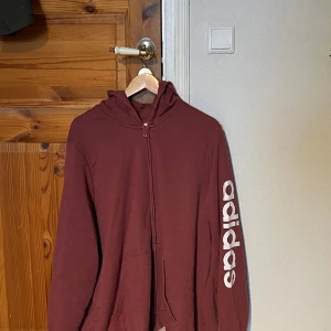Snygg vinröd hoodie - Hej! Säljer nu denna snygga Adidas hoodie. Den är knappt använd. Hör av dig vid intresse:)