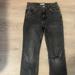 Utsvängda gråa jeans med en design med ett hål i ena knät. Jag säljer dessa pågrund av att de tyvärr är för små. Det är i storlek 36 men skulle tro att det passar storlek 34 mer. 
