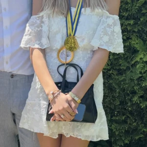 Vit spetsklänning offshoulder - Superfin vit kortklänning i spets med offshoulder och volangdetaljer. Klänningen har en romantisk känsla och är perfekt för sommarens alla tillfällen. Sitter snyggt och har en feminin siluett.