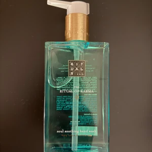 Rituals The Ritual of Karma Handtvål - Rituals The Ritual of Karma handtvål i en elegant turkos flaska med guldpump. Denna handtvål erbjuder en lugnande doftupplevelse med helig lotus och vit te. Perfekt för att ge dina händer en lyxig känsla varje dag.