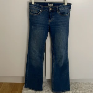 Blå bootcut jeans från ONLY - Säljer då de är för små, de är väl använda men i mycket bra skick och inga defekter💕Storlek s och längd 30. Slitningen på låret är inget som har tillkommit utan var där när jag köpte byxorna.