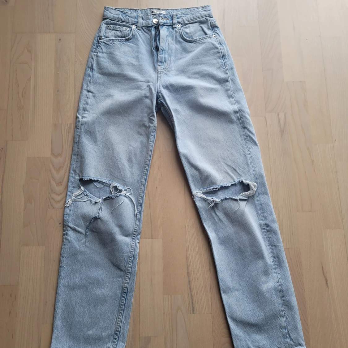 Ljusblå jeans med slitningar från gina tricot