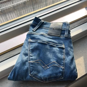 Replay Anbass hyperflex  - Snygga Replay Anbass jeans 28/32., normal passform och raka ben. Märkesdetaljer på ficka. Perfekta för en avslappnad streetstil och lite laidback.