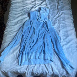 Ljusblå frottéhoodie från Paul & friends - Säljer en ljusblå hoodie från Paul & friends i mjuk frotté. Tröjan har huva med snörning och långa ärmar. Perfekt för dig som gillar chill och avslappnad stil. Passformen är normal och materialet känns riktigt skönt mot huden.