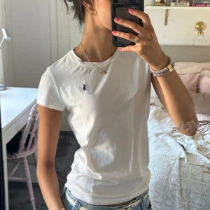 Vit t-shirt från Ralph Lauren - Hej!! Säljer denna jättefina T-shirt från Ralph lauren i storlek L i ungdomsstorlek. Jag skulle säga att den passar en xs. Liten slitning i tyget vid kragen om man tittar nära, därav priset. Tveka inte på att skriva vid frågor och pris kan diskuteras!🤗