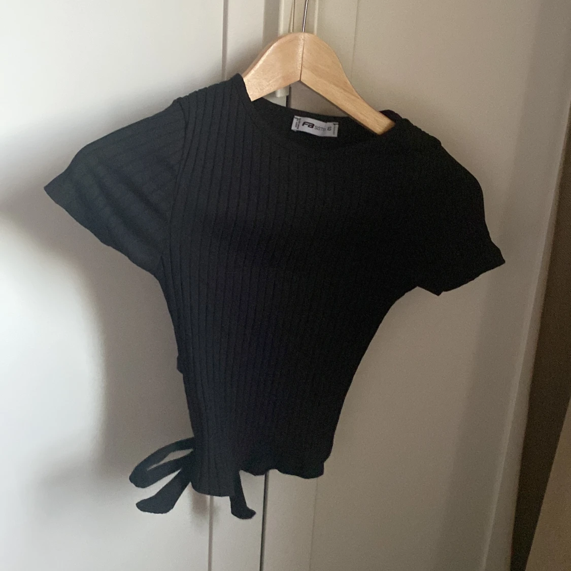 Svart ribbad topp med knyt från FB Sister