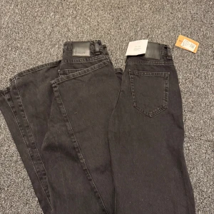 Svarta två stycken jeansbyxor med rak passform - Säljer två par svarta jeansbyxor från BikBok i modellen regular wide. Byxorna har hög midja, raka ben och klassiska femficksdetaljer. Perfekta för dig som gillar en avslappnad men stilren look.