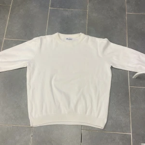 Vit tröja från Zara - Säljer en stilren vit tröja från Zara. Den har en klassisk design med rund hals och långa ärmar. Perfekt för en minimalistisk look. Passar bra till både jeans och chinos.