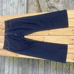 Mörkblå jeans från Dickies wide fit - Säljer ett par mörkblå jeans från Dickies. Byxorna har rak och bred passform med hög midja och robust denimkänsla. Dom är knappast använda och är i väldigt fint skick. Dom passar L om man vill ha en baggy look. 